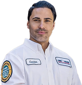 Man wearing a white service uniform shirt with a name patch and company logo, standing against a transparent background
