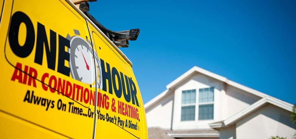 One Hour Air Conditioning & Heating service van parked in front of a residential home on a clear day